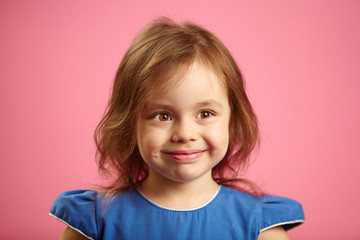 Children close-up portrait of beautiful girl with pretty eyes on isolated pink background.