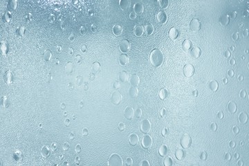Close up a glass texture of a bathroom with warm light at night