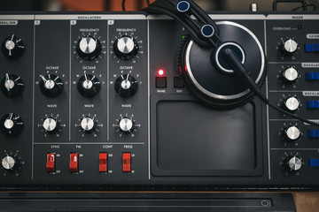 Professional synth board and stereo headphones in sound recording studio.High quality analog audio...