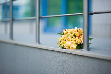 the bride s yellow bouquet lies under the railing
