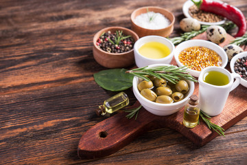 Fresh salad ingredients (salt, pepper, olive, tomato, rosemary, oil )