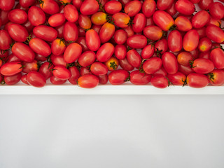 Fresh cherry tomatoes on white background