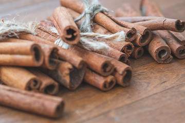 Cinnamon sticks close up on wooden background. Christmas time.