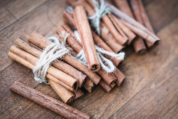 Cinnamon sticks close up on wooden background. Christmas time.