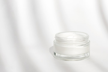 White facial cream jar. Cosmetic moisturizing product. Skin and body care, moisture lotion, wellness therapy mask in glass jar