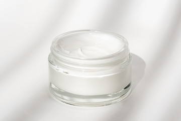 White facial cream jar. Cosmetic moisturizing product. Skin and body care, moisture lotion, wellness therapy mask in glass jar