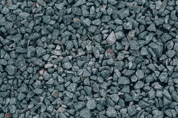 Gray pebbles. Background with beautiful small gray stones on the beach. Pebbles texture closeup. River rocks