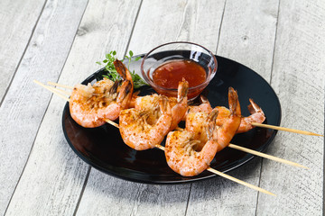 Grilled prawn skewer with sauce