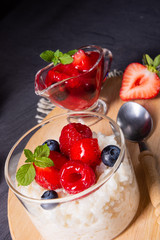 delicious milk rice with different berries and red fruit jelly