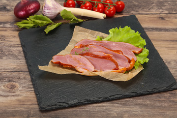 Sliced smoked duck breast served salad