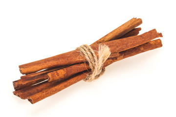 Cinnamon sticks heap isolated on white