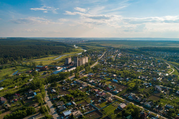 Aramil village, Elevator of flour mill and Iset river. Aerial, summer, sunny