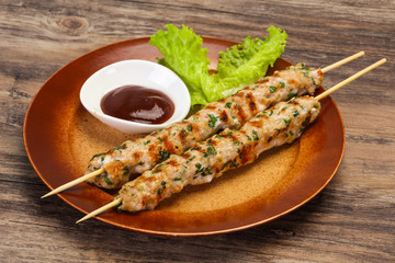 Minced pork skewer kebab with sauce