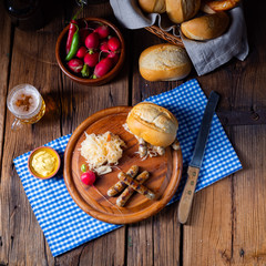 rustic Thuringian bratwurst with sauerkraut and roll
