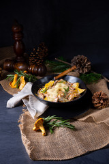Colorful farfalle pasta with chanterelles and cream sauce.