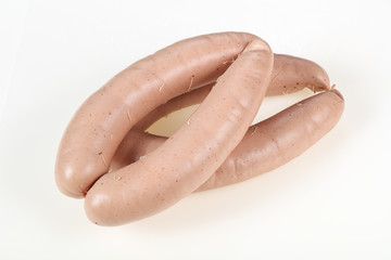 Tasty meat sausages over white background