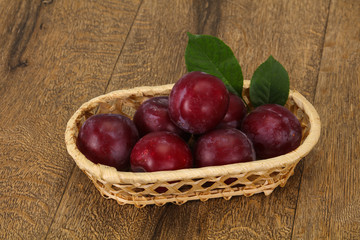 Plum heap in the wooden basket