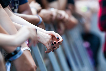 hands of fans waiting for a concert, hipsters, rock fans