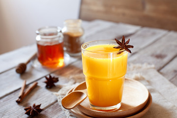 Golden tea with almond milk, turmeric and honey. Healthy detox morning beverage with spices