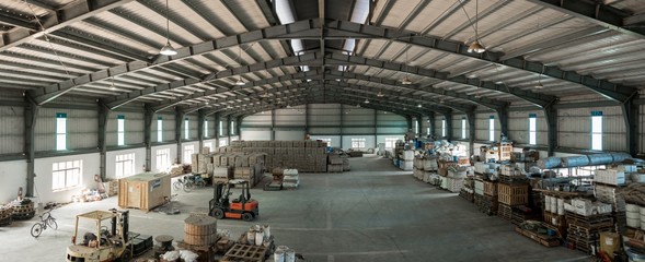 Wide shot of a warehouse with forklifts