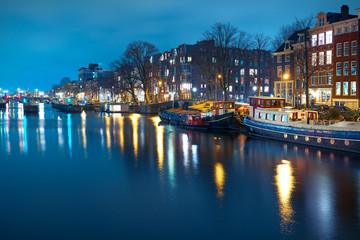 City landscape. Houseboat in the tourist area of Amsterdam at night.