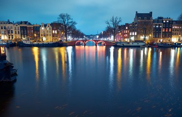 Cityscape at night. Bridge over a canal in Amsterdam, Netherlands.