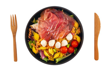 Salad made with cooked pasta, mixed green salads, cherry tomatoes, Mozzarella cheese and smoked ham served with accompaniment
