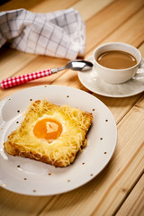 breakfast set with coffee and toast with egg on wooden table