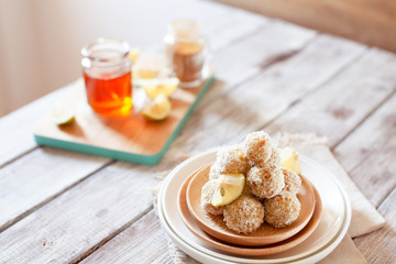 Healthy raw vegan candies with coconut and lemon, concept of tasty vegetarian food