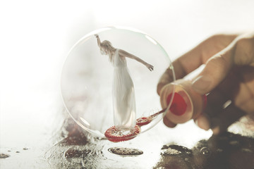 surreal image of a woman imprisoned in a soap bubble