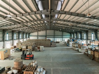 Interior shot of a warehouse with forklifts - obrazy, fototapety, plakaty