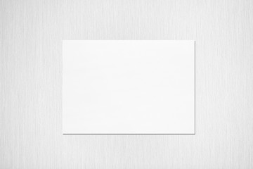 Empty white horizontal rectangle poster mockup with soft shadow on neutral light grey textured background. Flat lay, top view
