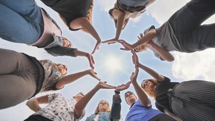 Conceptual symbol of cooperation diverse hands making a circle.