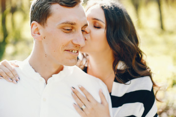 Fototapeta premium bright and happy pregnant woman walking in the park with her husband