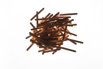 Many wooden ice cream sticks in heap on white background isolated, flat lay