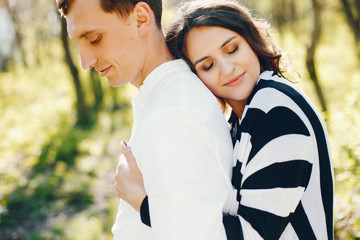 Fototapeta premium bright and happy pregnant woman walking in the park with her husband