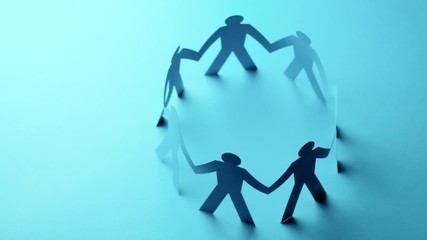 Concept of cooperation. Closed joining of paper figure in hand up posture on blue background. Successful and leadership.