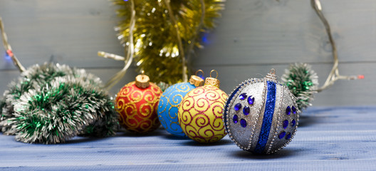Christmas balls decoration on blue wooden surface. Winter holiday concept. Decorate christmas tree with traditional toys. Symbol of new year and christmas holidays. Various christmas decorations