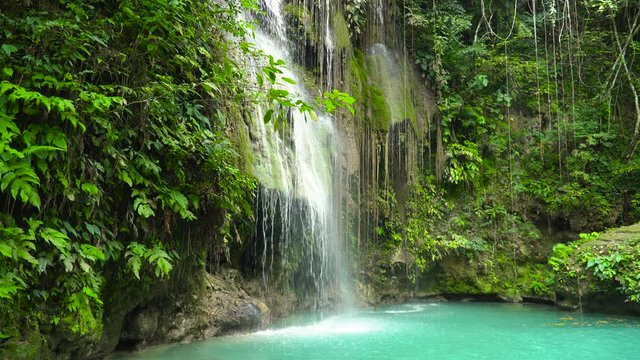 Cambais waterfalls in a mountain gorge in the tropical jungle, Philippines, Cebu. Waterfall in the tropical forest.