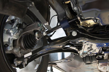 Fototapeta na wymiar Close-up on the front suspension of a modern car. MacPherson suspension. Technical photography