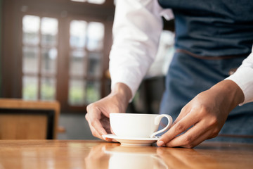 Young owner of coffee cafe service customer.