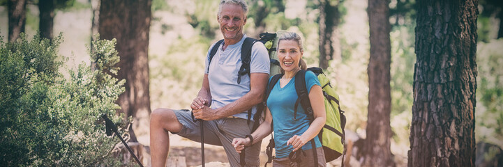 Couple smiling and posing during a hike 