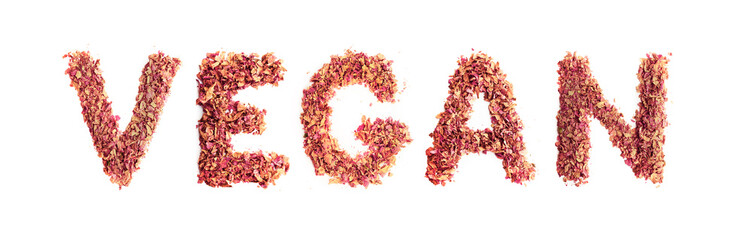 Food typography word Vegan made of dried rose petals. Clean and healthy eating concept. Isolated on white background