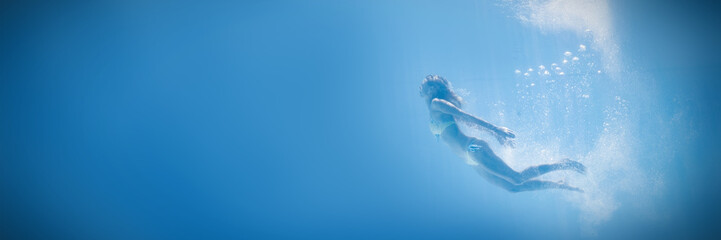 Fit woman swimming under water
