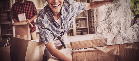 Happy couple unpacking cartons together
