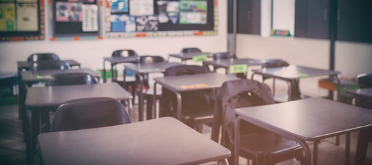 Empty classroom with desks and chairs