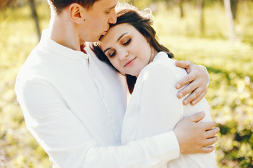 Fototapeta premium bright and happy pregnant woman walking in the park with her husband