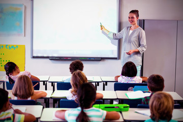 Teacher teaching children using projector 