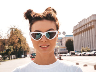 Beautiful smiling model with horns hairstyle dressed in summer hipster clothes.Sexy carefree girl...