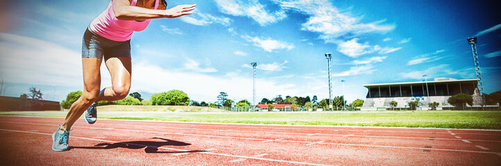 Female athlete running on running track